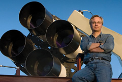 Los Alamos National Laboratory astrophysicist Tom Vestrand poses with the fast-slew array of telescopes for RAPTOR (RAPid Telescopes for Optical Response) system.